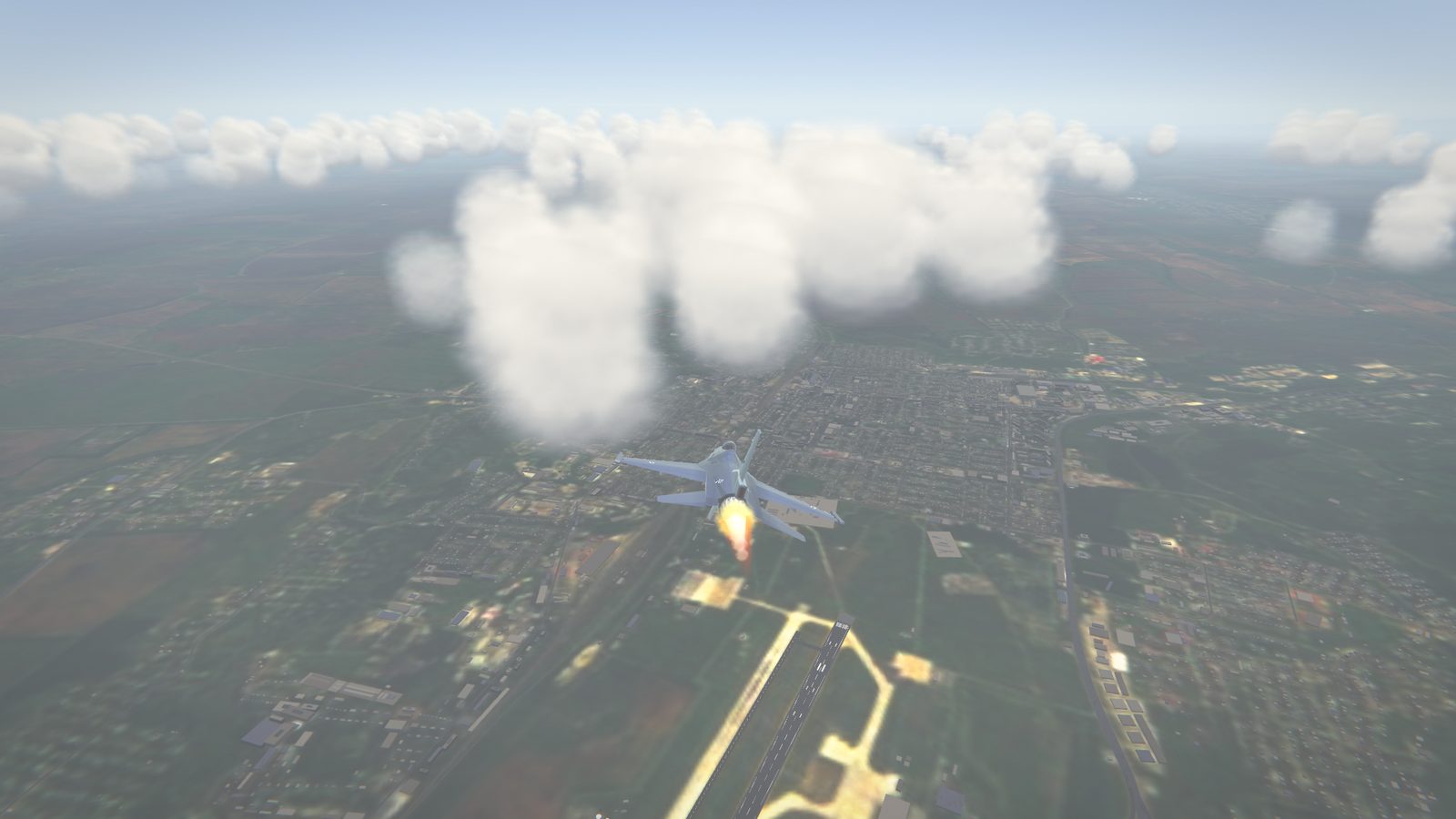 Approaching an airfield, with buildings and runway