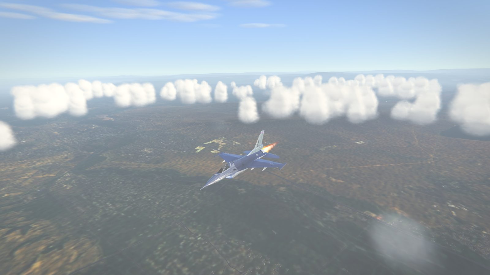 An F-16 on afterburner over the Caucasus, between scattered clouds
